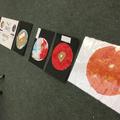 Photograph of a series of worksheets where children have designed their own planet. The planets are 2 dimensional and are made of craft materials.