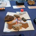 Photograph of some volcanic rocks displayed on a jigsaw puzzle of a volcano