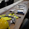 A photograph of some fieldwork equipment, including a hard hat and high-vis gear, displayed on a lab bench