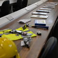 A photograph of some fieldwork equipment, including a hard hat and high-vis gear, displayed on a lab bench