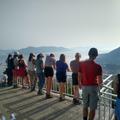 Photograph of students relaxing on the Greece field class, overlooking a viewpoint, with their backs to the camera.