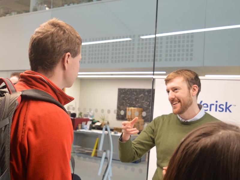 Careers Fair Photograph of an alumnus speaking to an undergraduate at the careers fair.